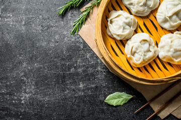 Fresh dumplings of manta with meat in a bamboo steamer.