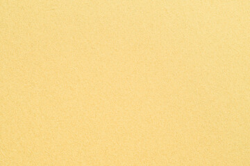 Background with coastal sand. A well-groomed shore with clean yellow sand.