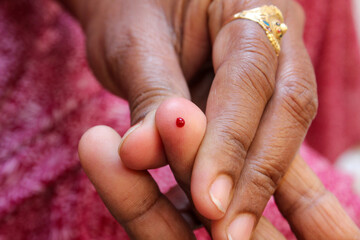 The concept of taking blood for glucose and hemoglobin test finger pricking