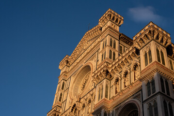 Part of the facade of an ancient building Duomo in Florence, sunset, close up.