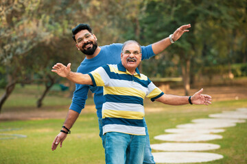 Fototapeta premium Old indian father with his young son spending time at park.