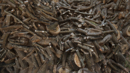 A stack of firewood prepared to heat the house. Firewood for heating ready in the winter. Chopped environment wallpaper. 
