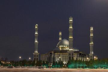 Panoramic view of snow-white modern Hazaret Sultan mosque at night, Nur-Sultan, Astana, Kazakhstan....