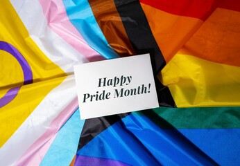 HAPPY PRIDE MONTH inscription positive quote phrase Greeting card on Rainbow LGBTQIA flag made from...