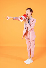 Photo of young Asian businesswoman holding megaphone on background