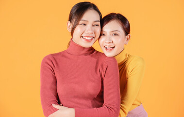 Image of two young Asian woman on background