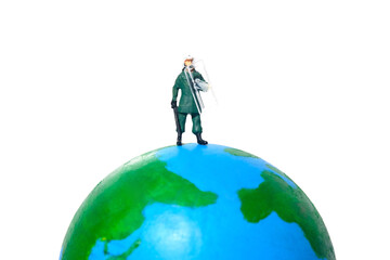 Miniature people toy figure photography. A military anti riot armored army standing above earth globe. Isolated on white background