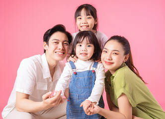 Image of young Asian family on background