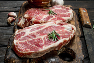 Raw pork steaks with spices.