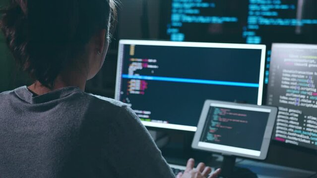 Young Asian woman, developer programmer, software engineer, IT support, working hard at night overtime on computer to check coding in bugging system