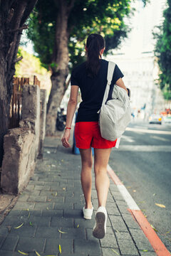 Girl tourist walking along a busy street