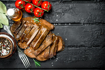 Grilled beef steak with spices and tomatoes.