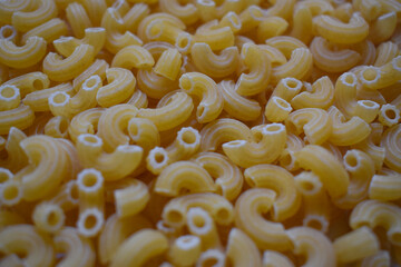 Background from macaroni pipa rigata. Raw, uncooked. Top view, close-up.