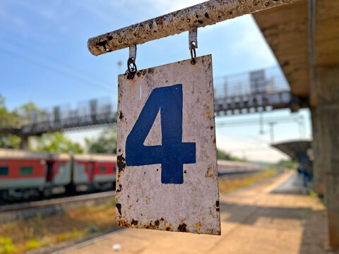 Number four (4) signpost on a very old fully rusted signboard railway station platform in Indian state of Goa