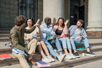 Fototapeta premium student friends giving each other a high five.