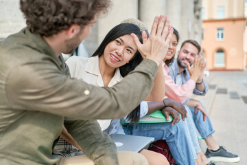 Fototapeta premium happy students giving each other a friendly high five.