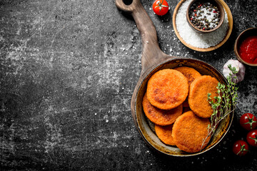 Fish cutlets with spices,thyme, garlic and sauce in bowl.