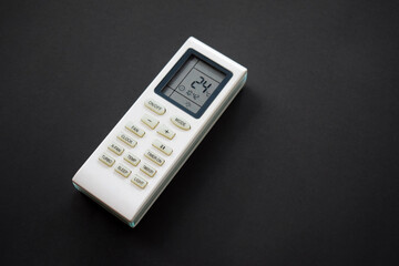 Air conditioner remote on black background. Close up of air conditioner 24 degrees celsius