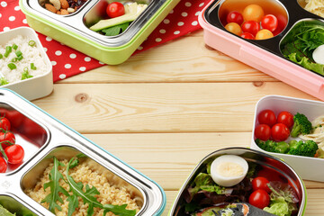 Containers with healthy food on wooden background top view.