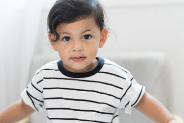 Close up of cute little boy playing in living room at home