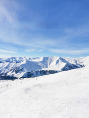 Fototapeta na wymiar Ski resort. View of snowy slope and years. Winter recreation. Gudauri Georgia