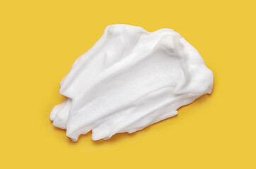 Shaving cream isolated on yellow color background	