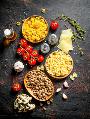 Different types of raw paste with thyme, tomatoes and mushrooms.