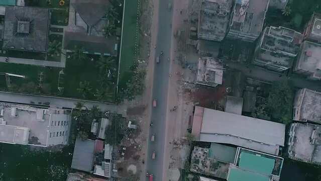 Areal shot of a road from a rural area where vehicle's are passing