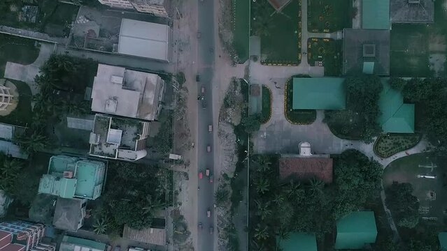 Full HD drone shot of a local road where vehicles are passing 