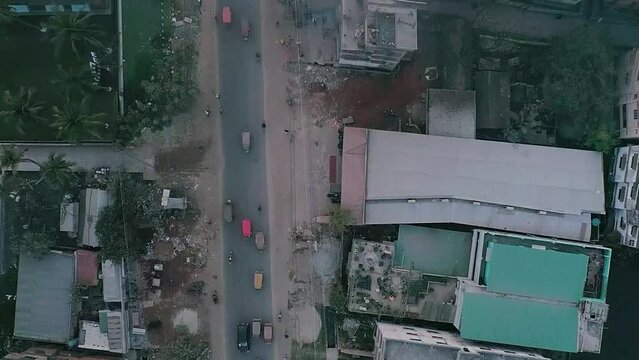 Drone shot of a  road from rural city vehicles are passing