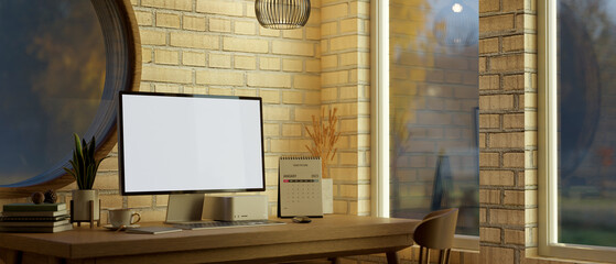 Vintage home workspace with PC desktop computer against the circle window with brick wall