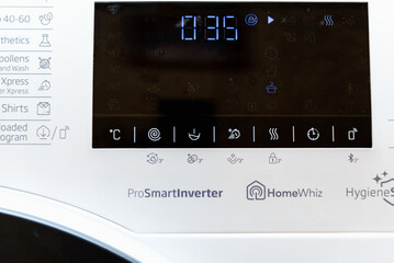 Display washing dryer machine. Macro photo part of modern home washing dryer machine dial.