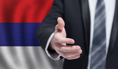 Serbian business, politics, cooperation and travel concept. Hand on flag of Serbia background.