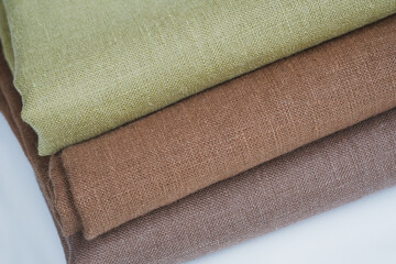 Fototapeta na wymiar Green and brown linen background. Stripes of fabric