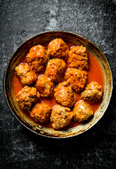 Meat balls in pan.
