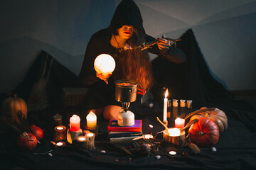 Close up magician with glowing ball eating portrait picture. Witchcore blackout. Closeup front view...