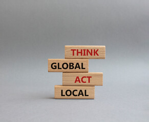 Think global act local symbol. Wooden blocks with words Think global act local. Beautiful grey background. Business and Think global act local concept. Copy space.