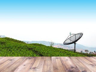 Wooden table top over satellite dish in green tea farm