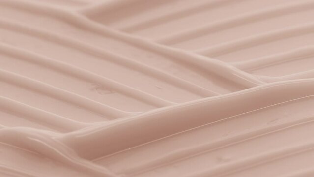 Macro crane shot of beige moisturizing cream with niacinamide and vitamin B5 wave texture | Moisturizing cream background shot for its commercial