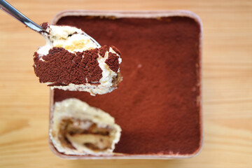 Closeup of Spoon Scooping Mouthwatering Tiramisu
