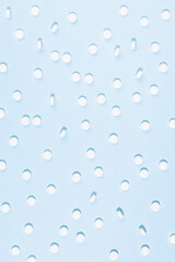 White tablets or pills pattern on soft light pastel blue color in hard light, top view, vertical. Pharmacy background in simple style, medical, treatment remedies for prevent, teraphy disease.