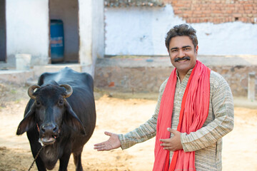 Rural scene : Indian farmer standing his dairy farm