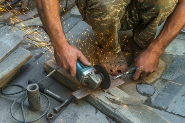 man welding electric steel with sparks and circular pipe