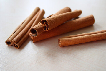 Fresh cinnamon sticks on a rustic wooden background