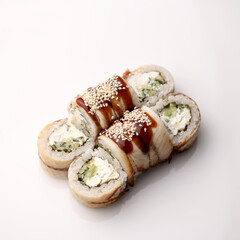 Sushi rolls with eel, cucumber and soft cheese. White background. View from above. Serving dish.
