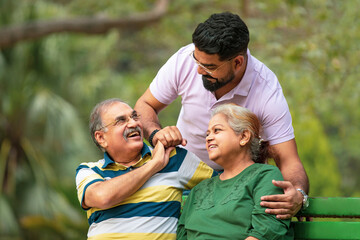 Young Indian man with his parents at park