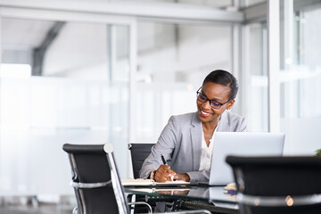 Successful black woman manager writing notes