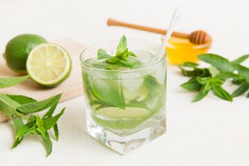 Mojito cocktail. Refreshing mojito cocktail with lime, lemon and mint in a tall glass with a stick
