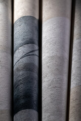 A roll of vinyl wallpaper with a beautiful paper texture in low light