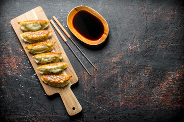 Freshly cooked dumplings gedza with soy sauce.